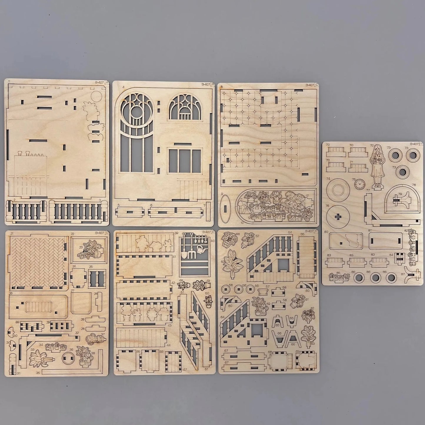 The book-nook model parts on a wooden surface