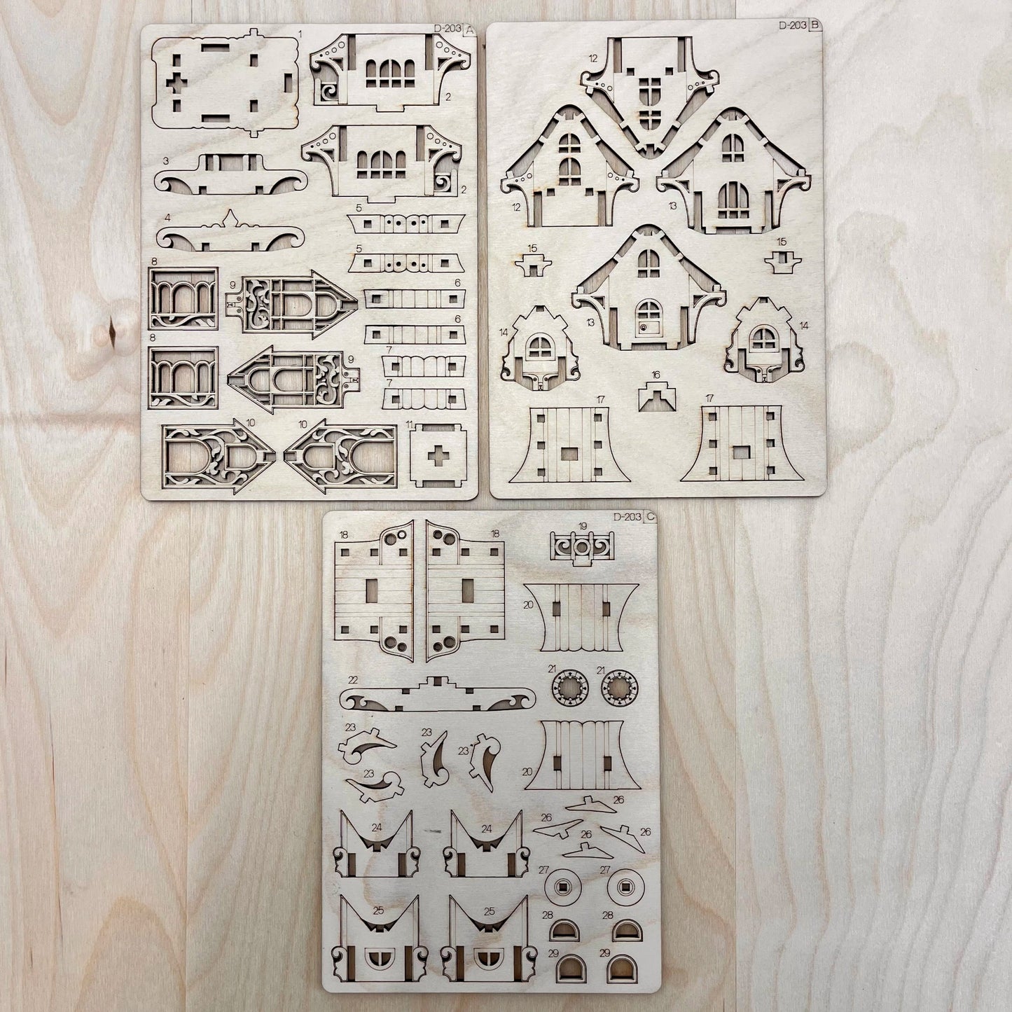 Set of caravan house model parts on a wooden surface