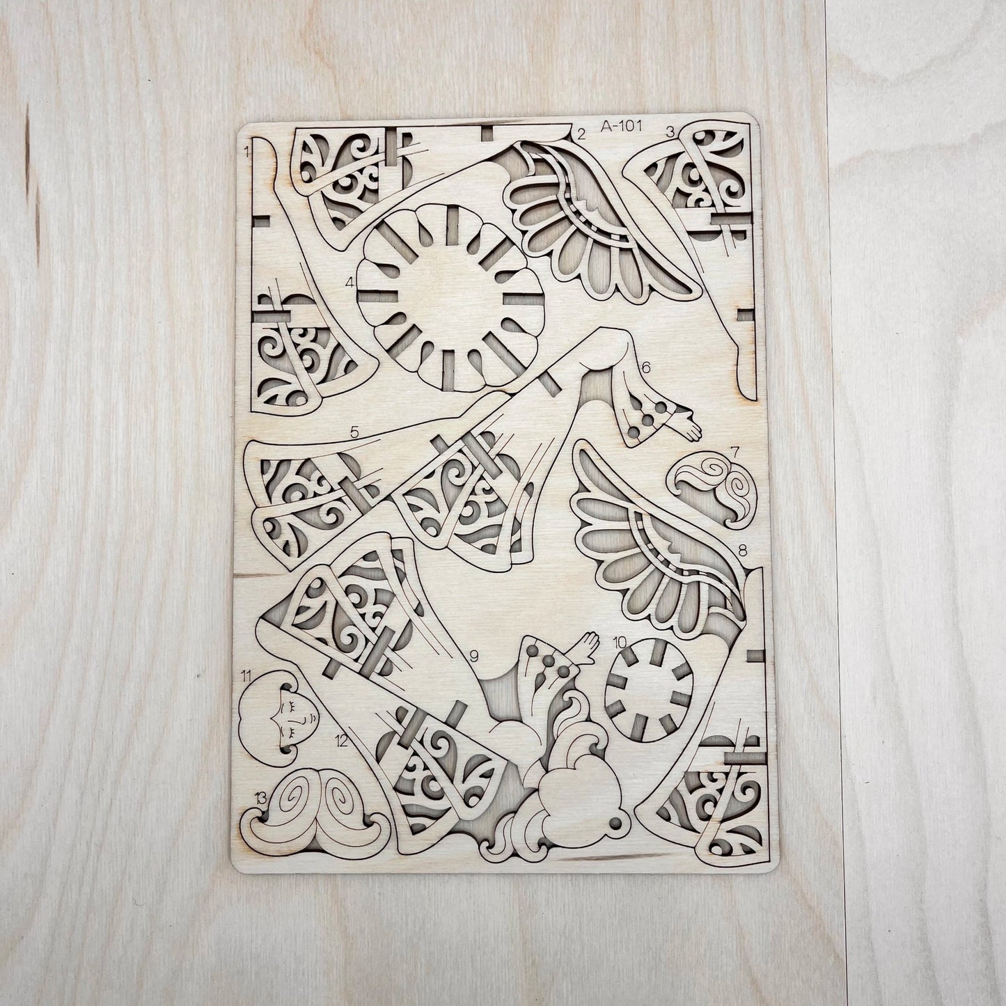 The little angel model parts on a wooden surface