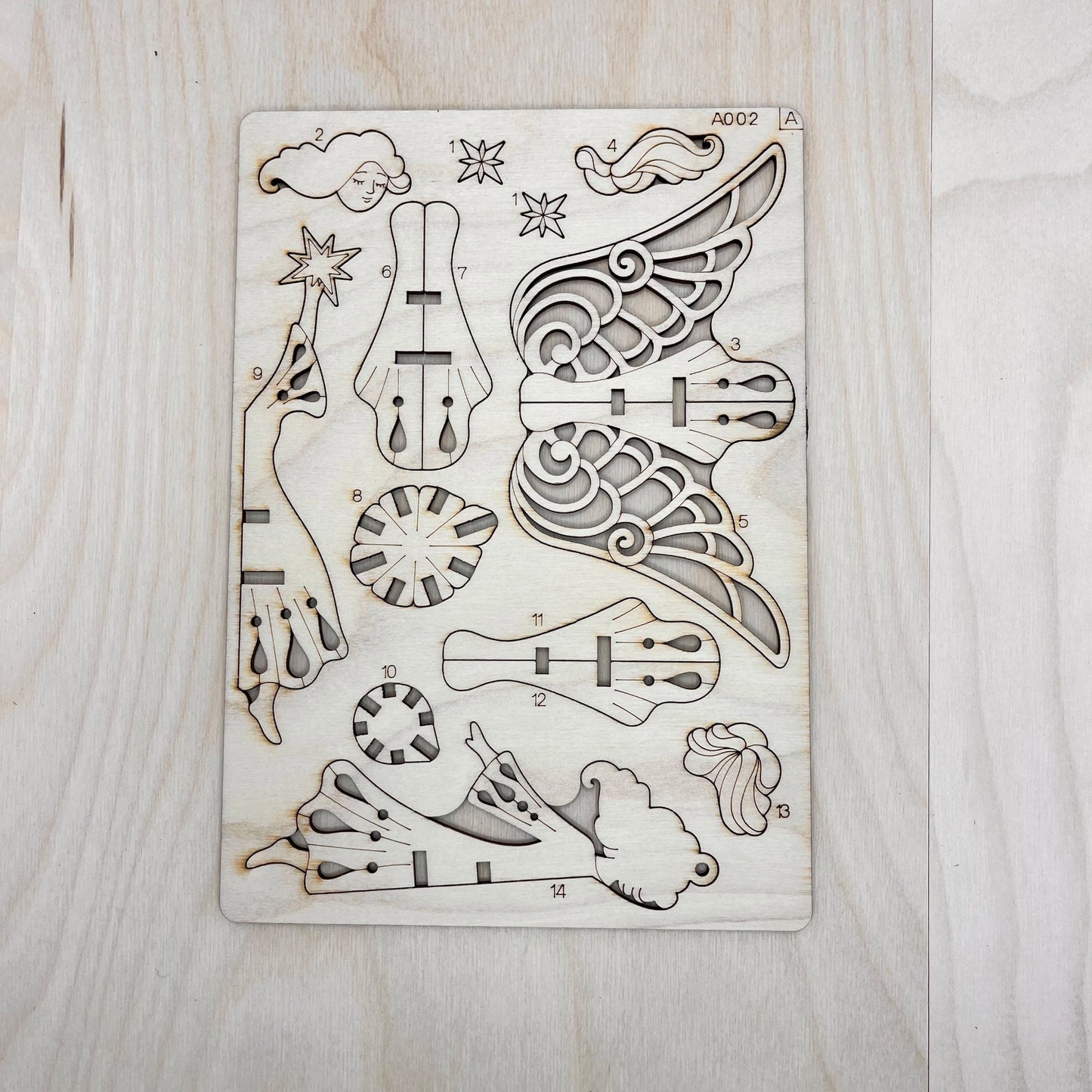 The starlight angel model parts on a wooden surface
