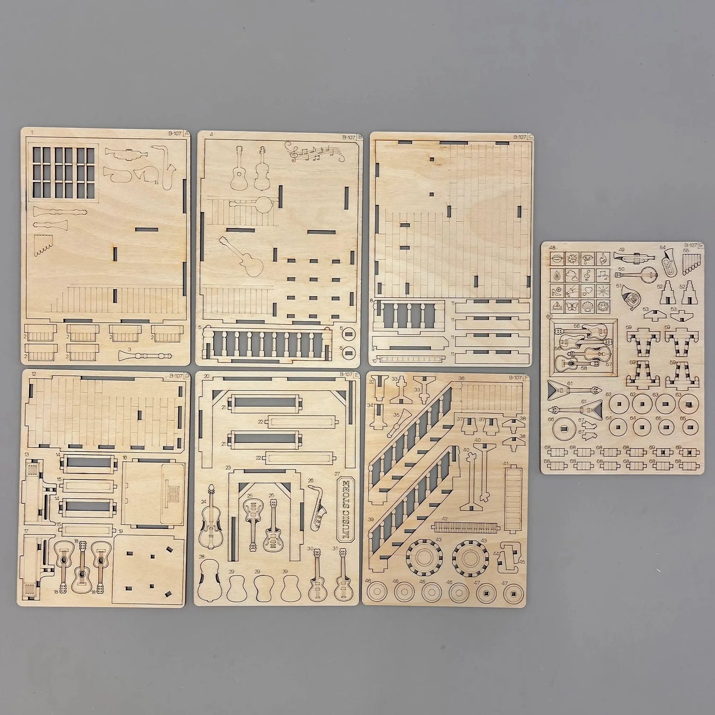 Set of laser-cut wooden models on a gray background