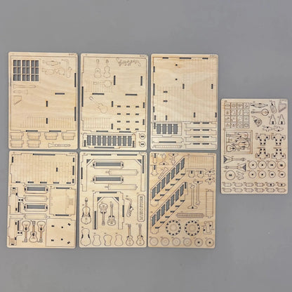 Set of laser-cut wooden models on a gray background