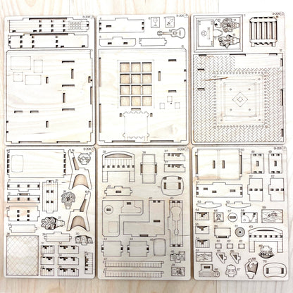 Set of laser-cut book nook model parts on a wooden surface