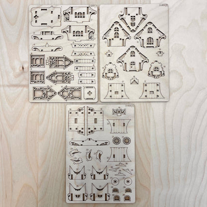Set of caravan house model parts on a wooden surface