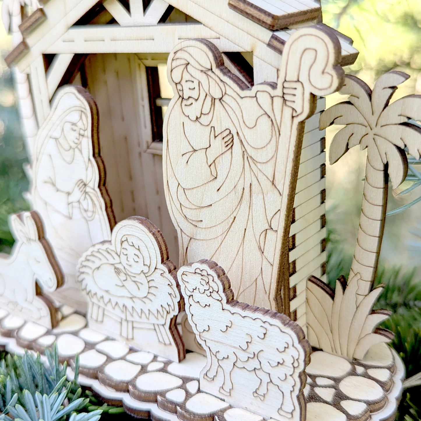 Wooden nativity scene with Mary and Joseph in a stable setting.