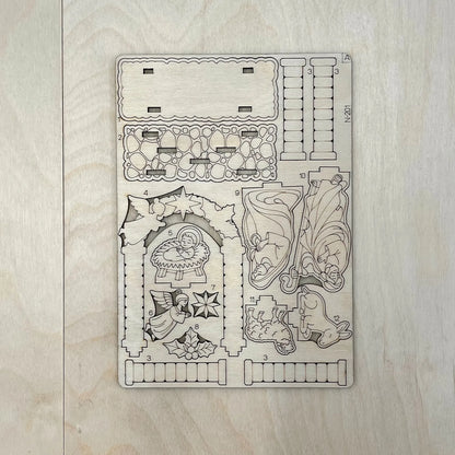 Decorative wooden template with Christmas-themed cutouts on a wooden surface