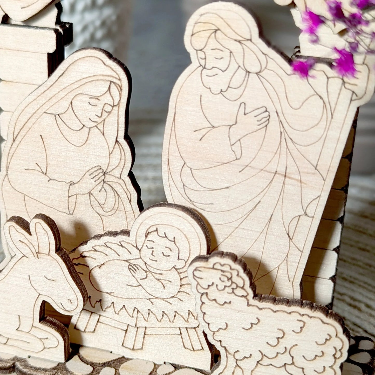 Wooden nativity scene with Mary, Joseph, and baby Jesus.