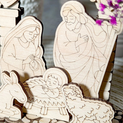 Wooden nativity scene with Mary, Joseph, and baby Jesus.
