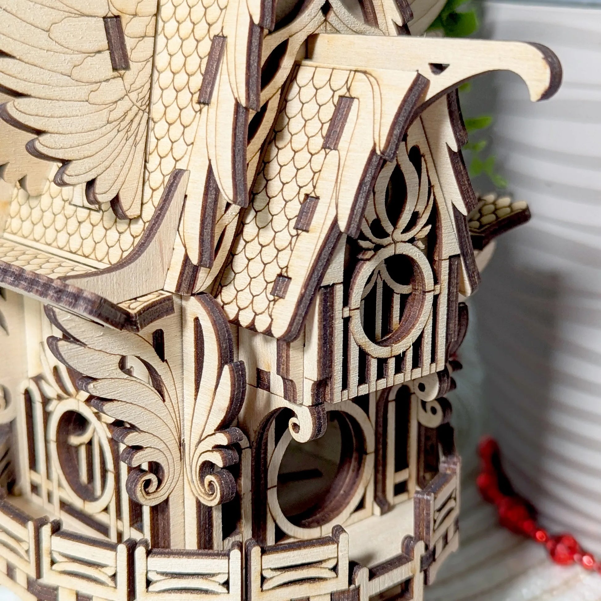 Wooden birdhouse with intricate designs on a blurred background