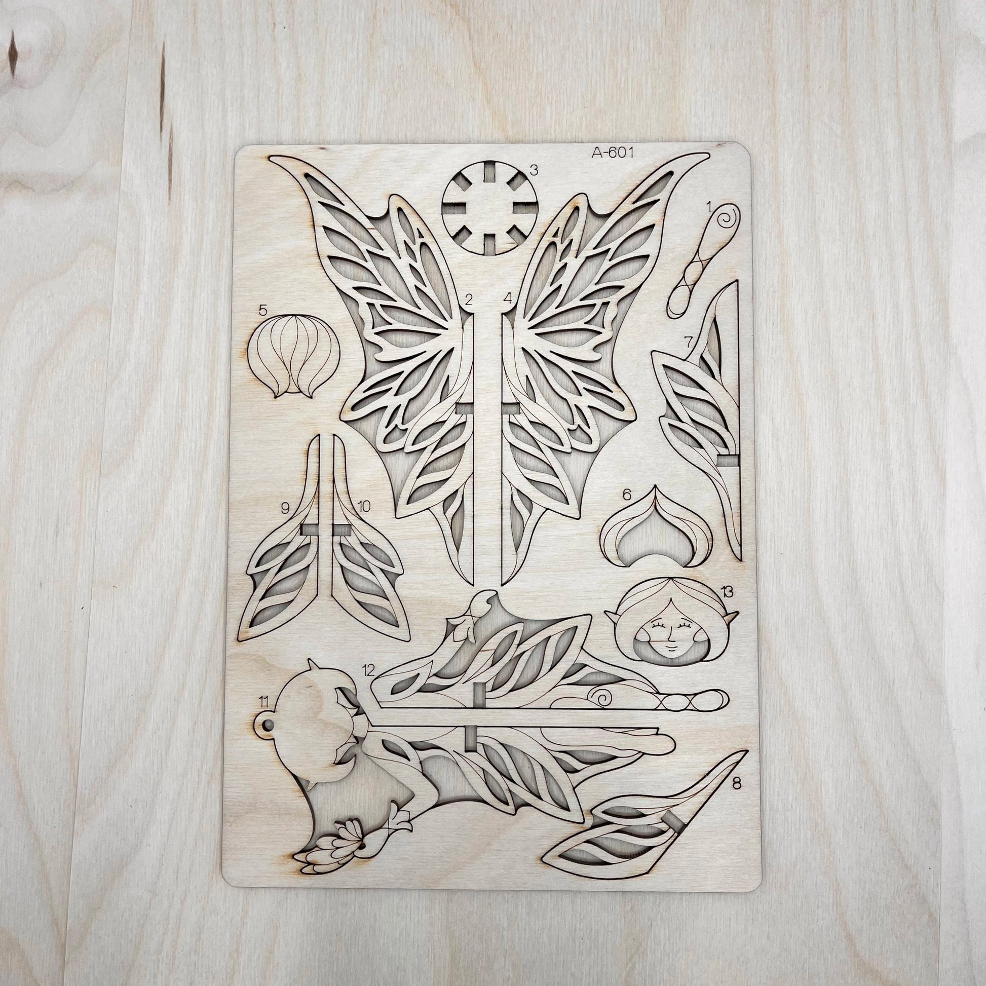 the fairy model parts on a wooden surface