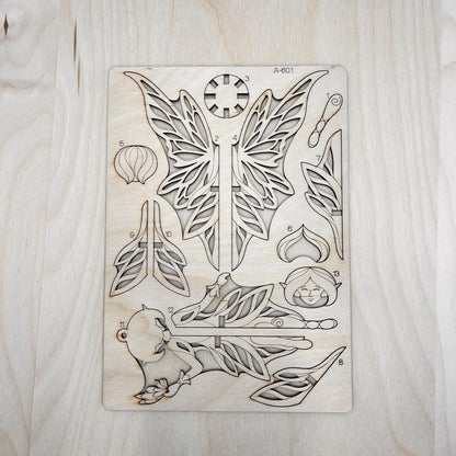 the fairy model parts on a wooden surface