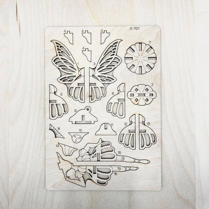wooden cut shapes including butterfly and floral designs on a wooden surface