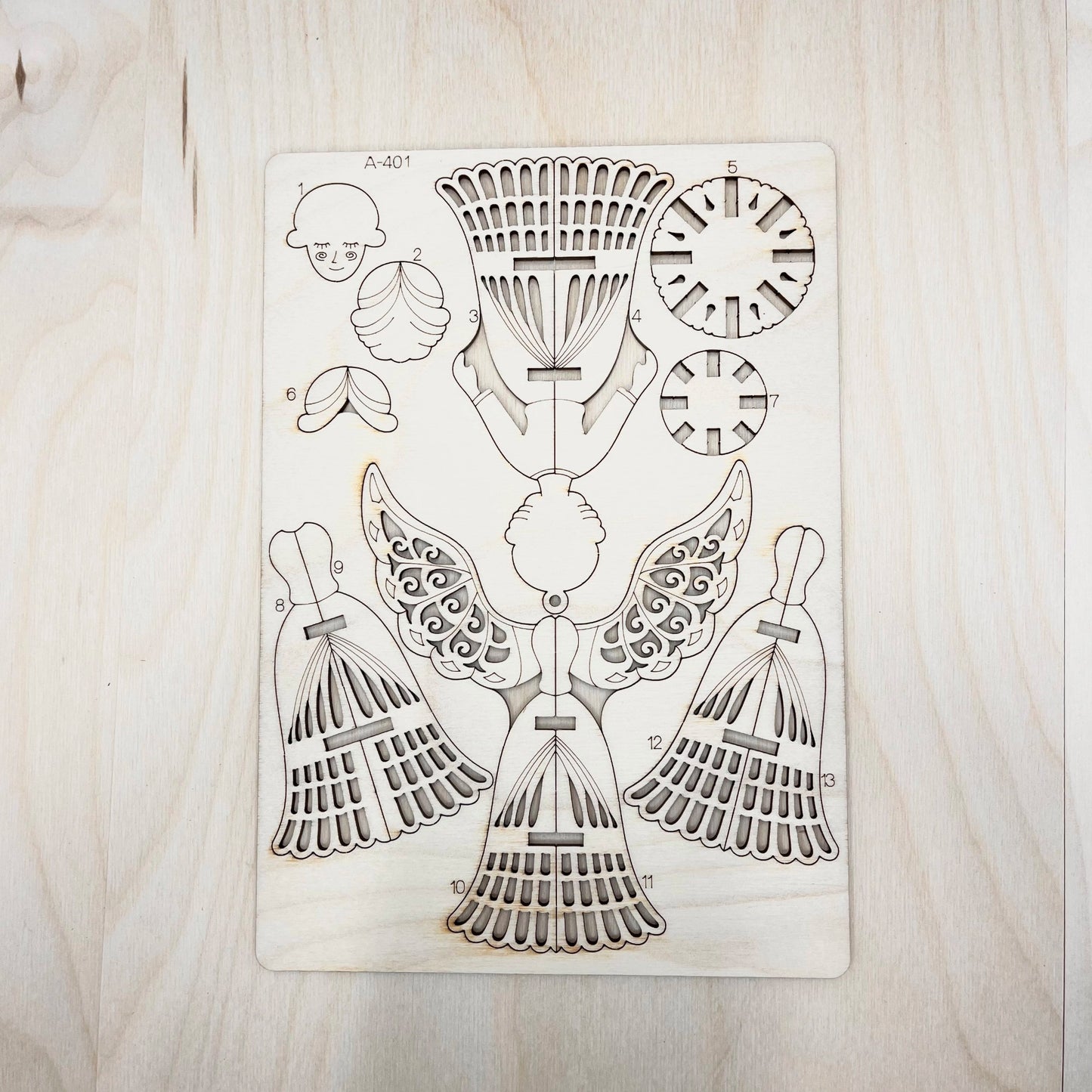 Wooden laser cutout with geometric designs on a wooden surface