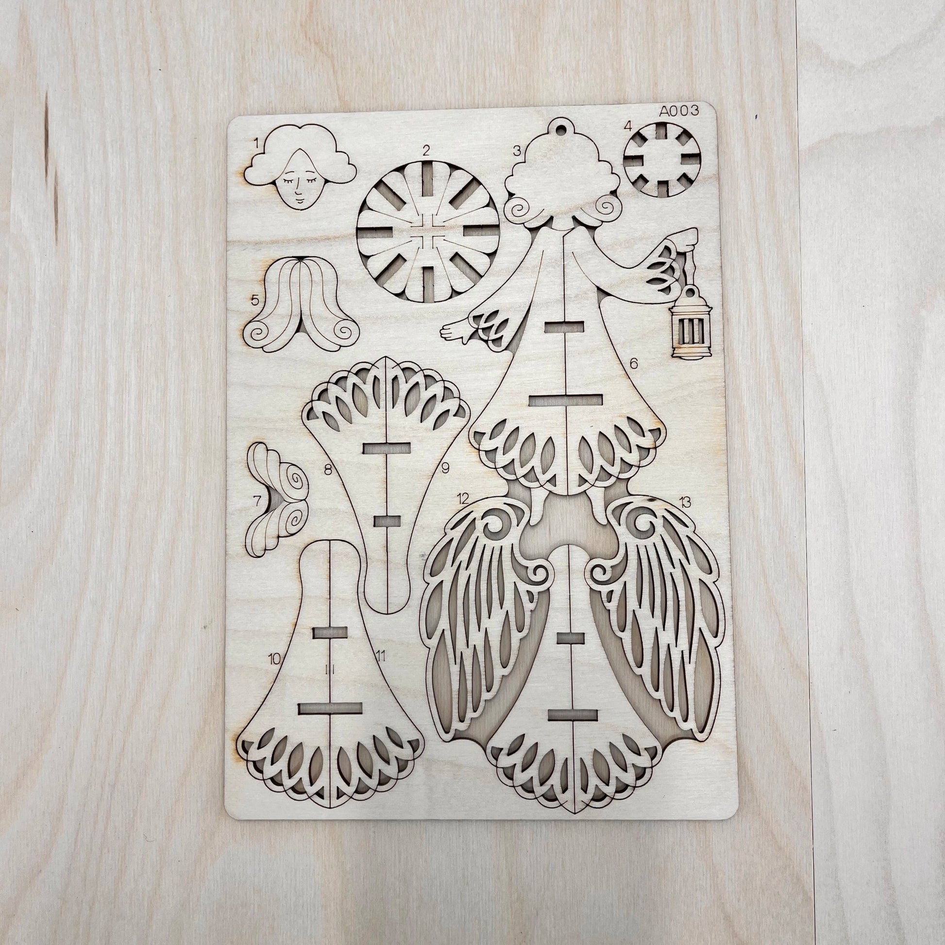 The holy angel model parts on a wooden surface