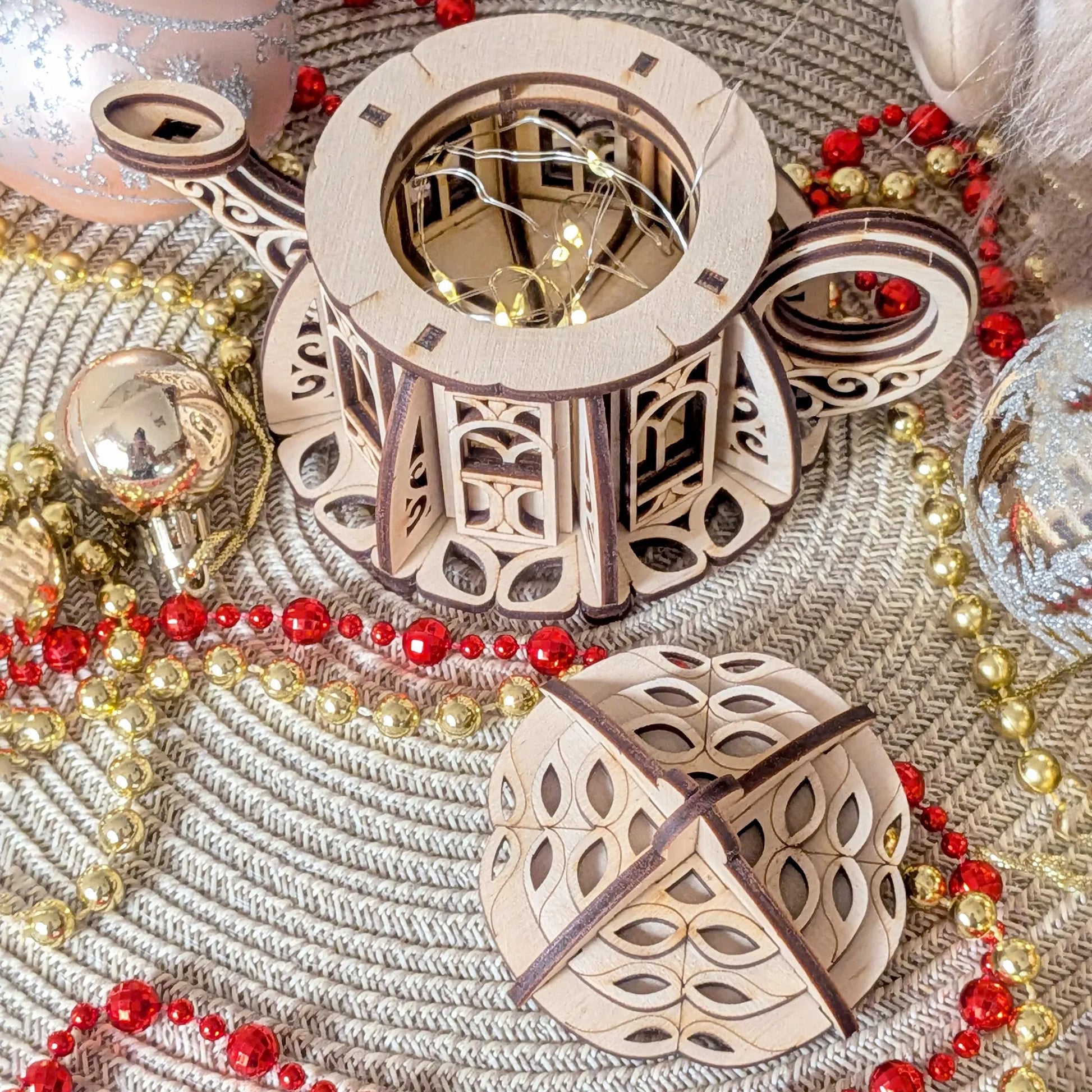 Handmade Style Wooden Teapot House with intricate designs on a textured surface with red and gold beads.