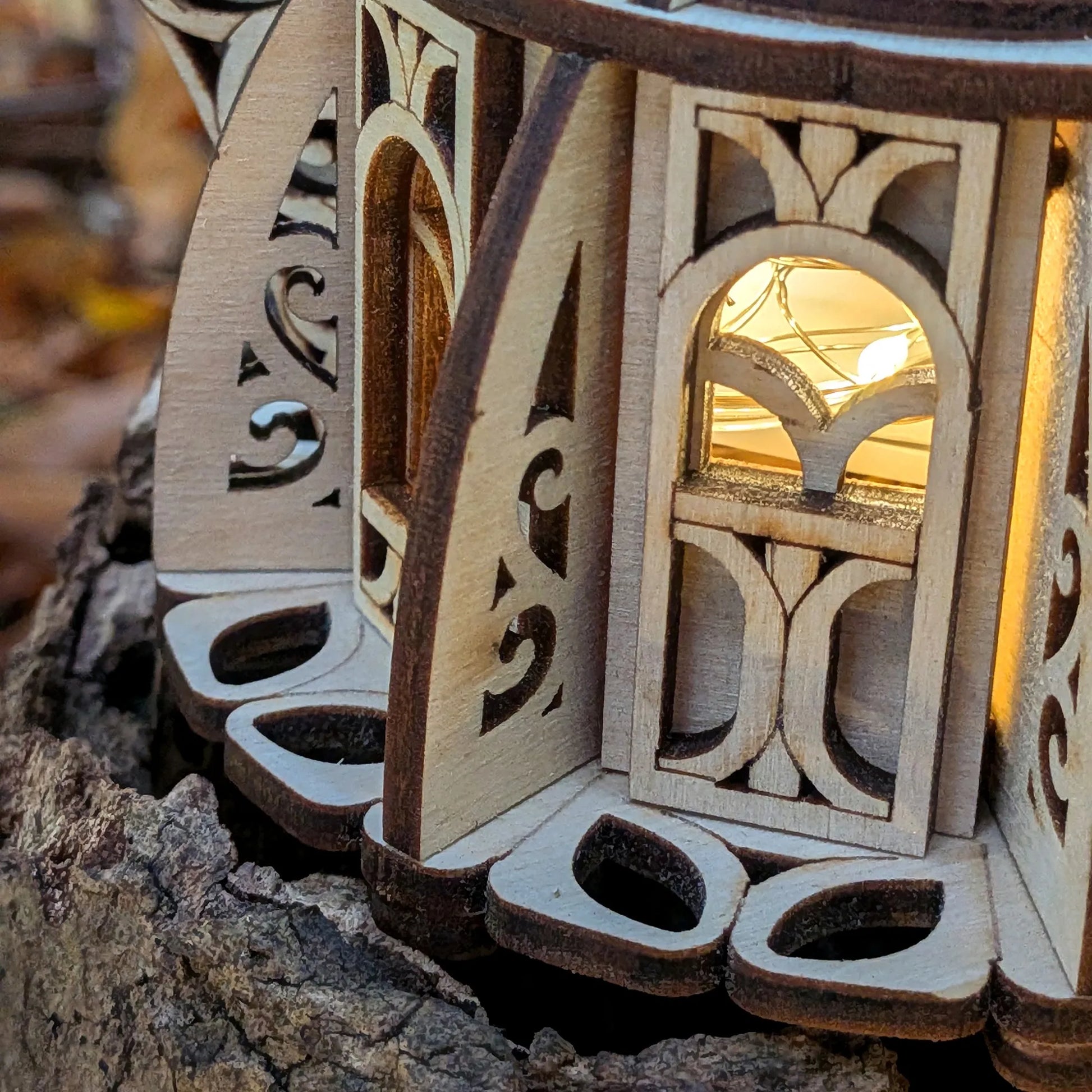 Wooden lantern with intricate carvings on a natural background