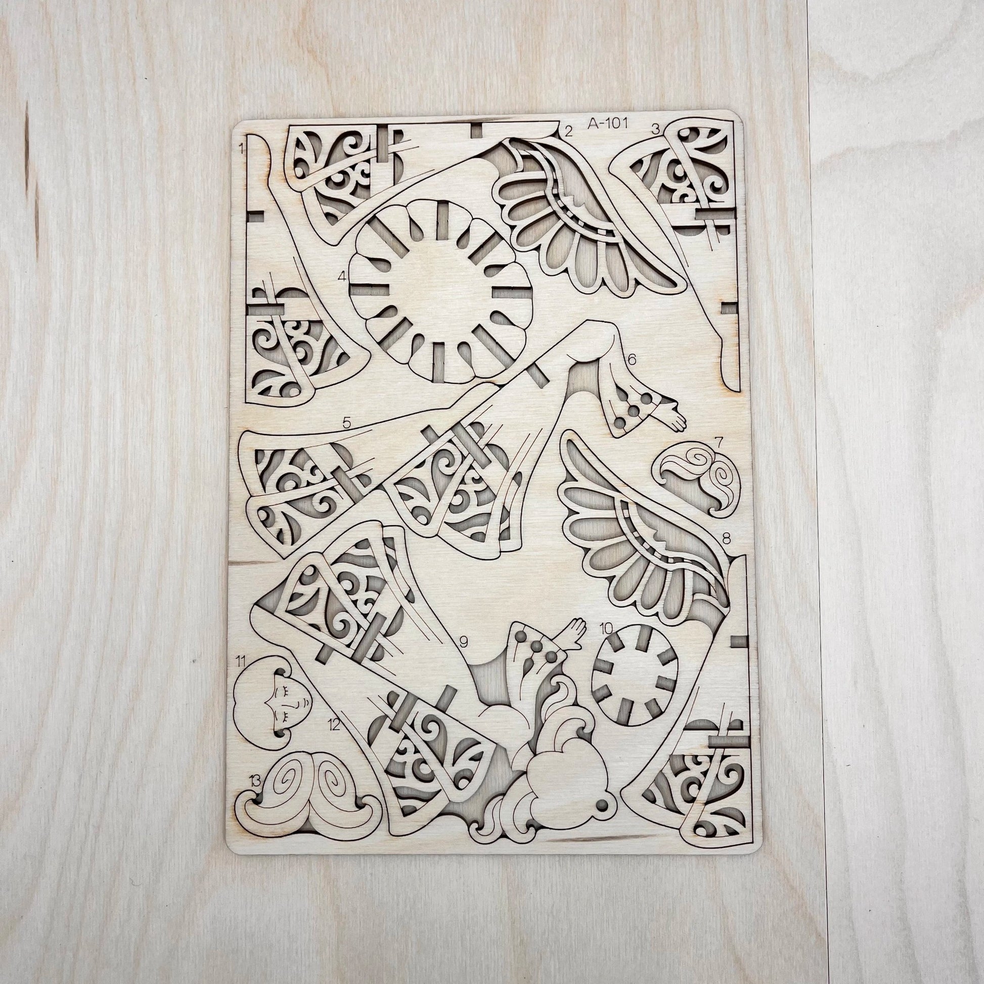The little angel model parts on a wooden surface