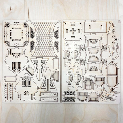 Two sheets of architectural floor plans on a wooden surface