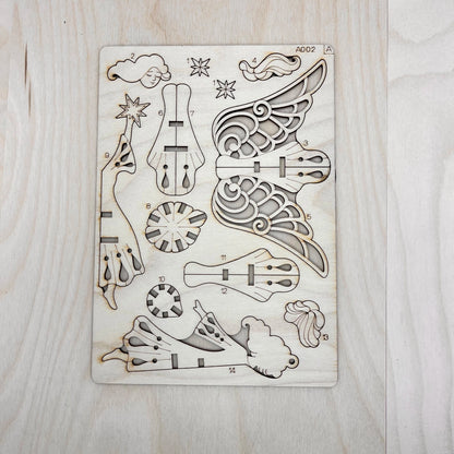 The starlight angel model parts on a wooden surface