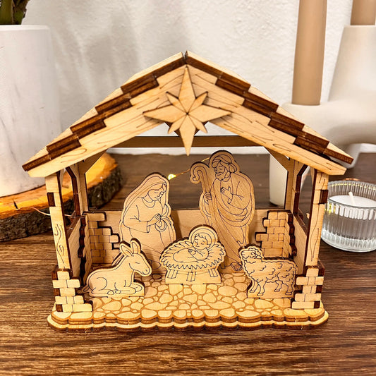 Wooden nativity scene with stable on a wooden surface