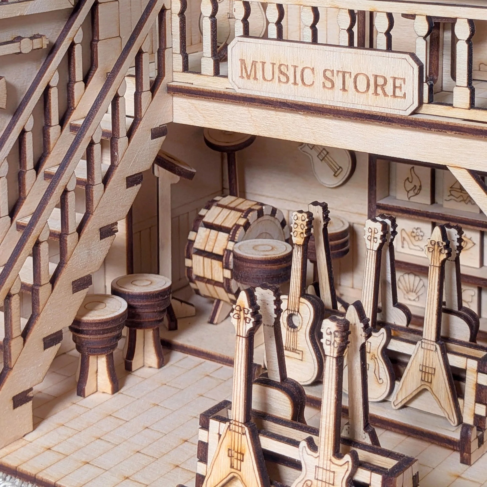 Wooden model of a music store with instruments and a staircase.