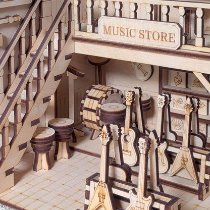 Wooden model of a music store with instruments and a staircase.