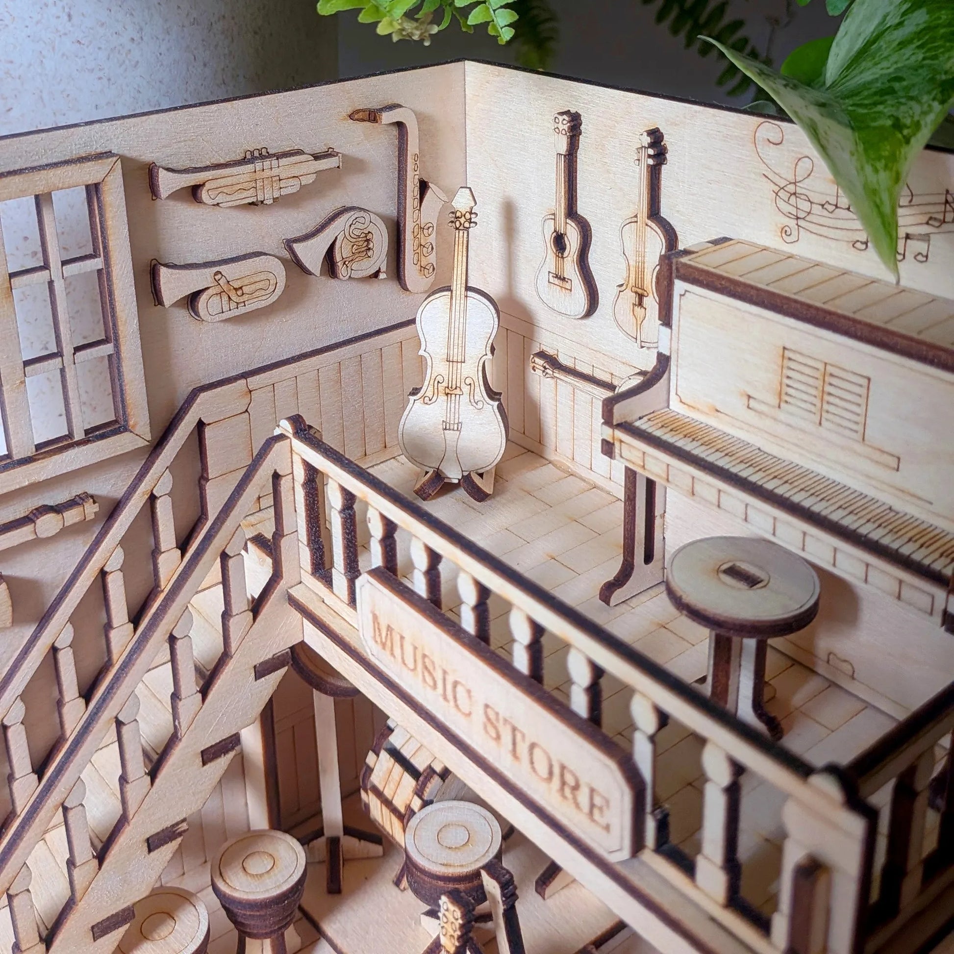 Wooden model of a music store with instruments and a staircase.