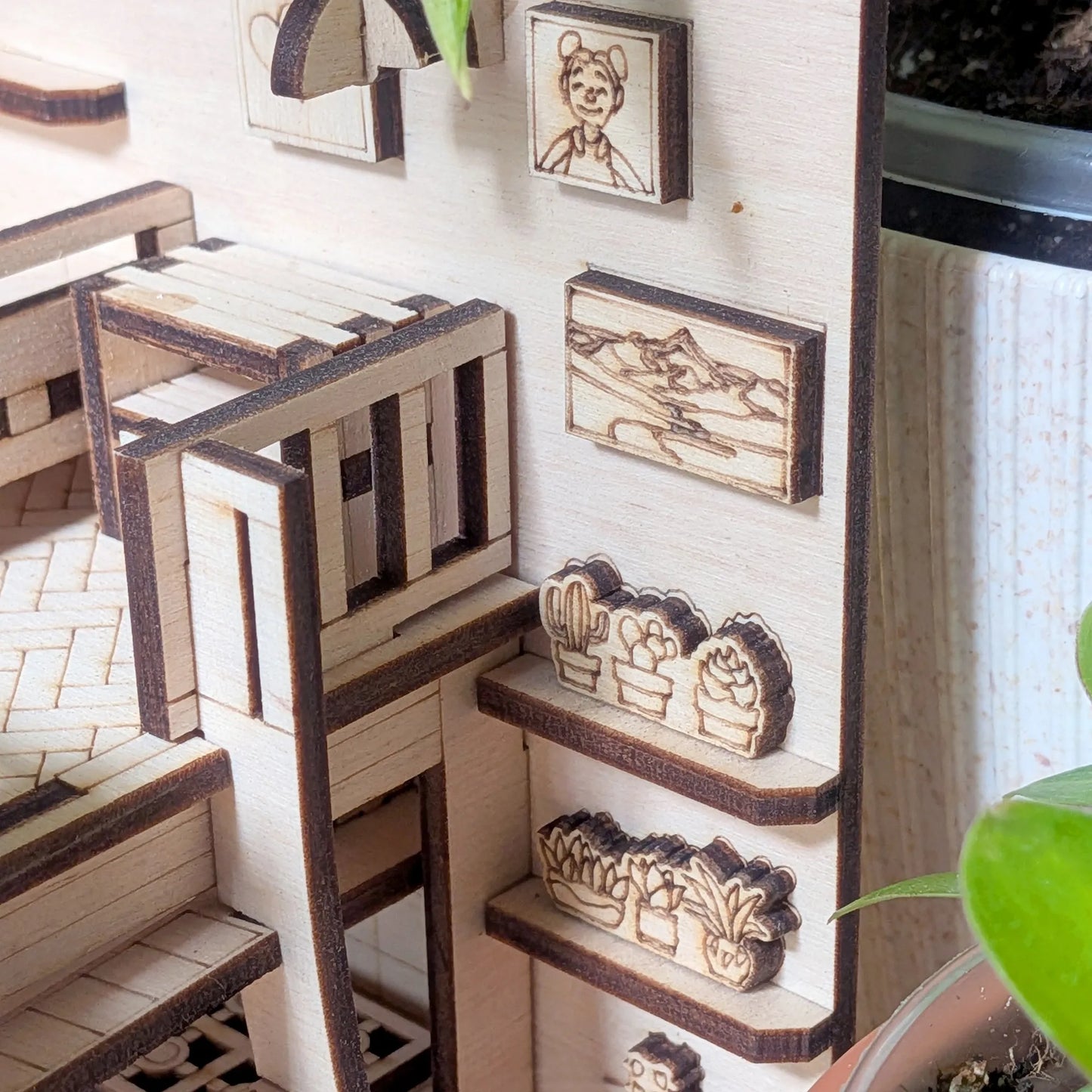 Miniature wooden shelves with decorative items in a dollhouse setting
