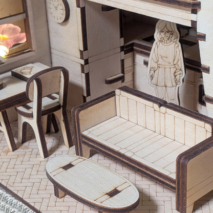Wooden dollhouse furniture set with a small figure inside, including a bed, chair, and table.