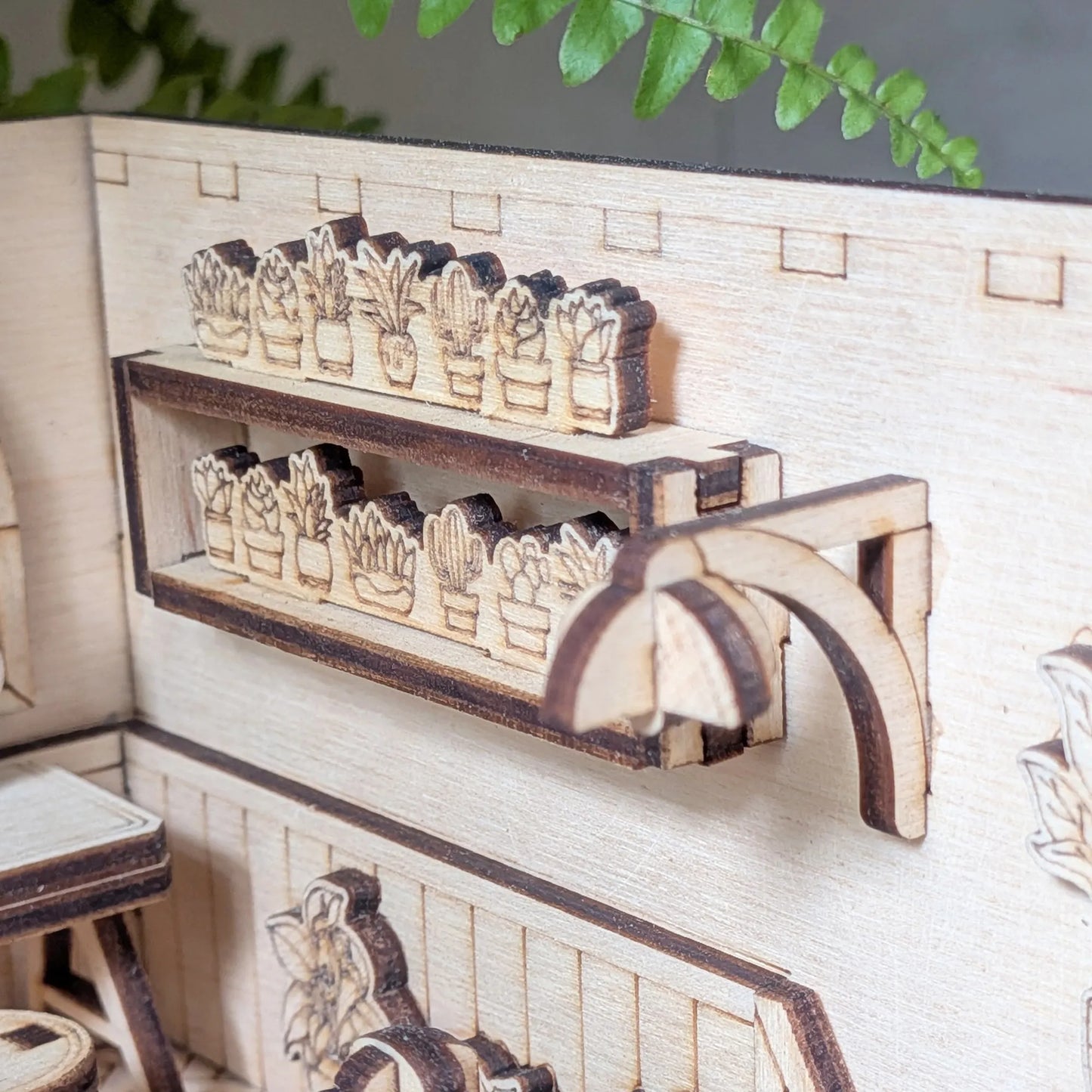 Wooden model of a shelf with plants in a miniature setting