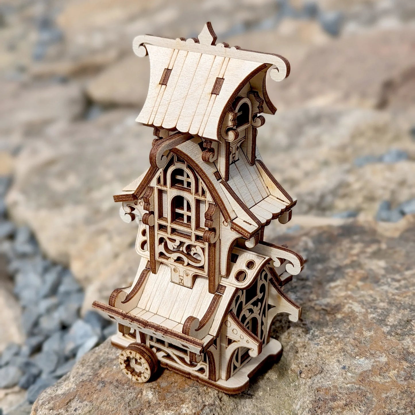 Wooden model of a decorative building on a stone surface