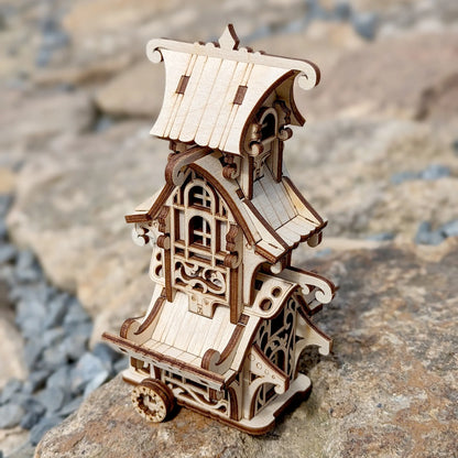 Wooden model of a decorative building on a stone surface