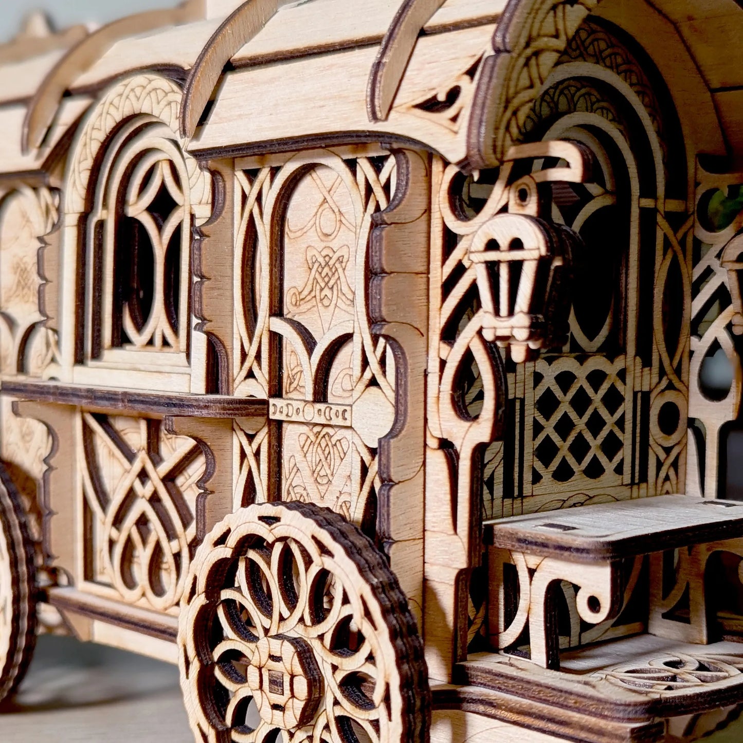 Wooden model of a decorative carriage with intricate carvings