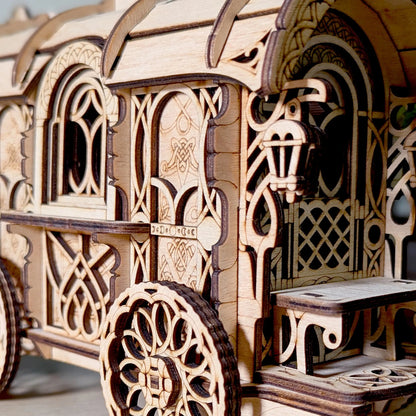 Wooden model of a decorative carriage with intricate carvings