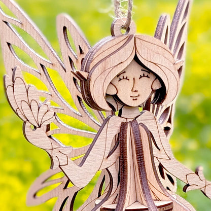 Wooden angel ornament with a blurred green background