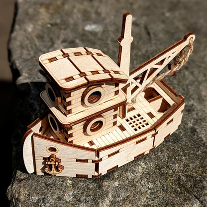 Wooden model ship on a stone surface