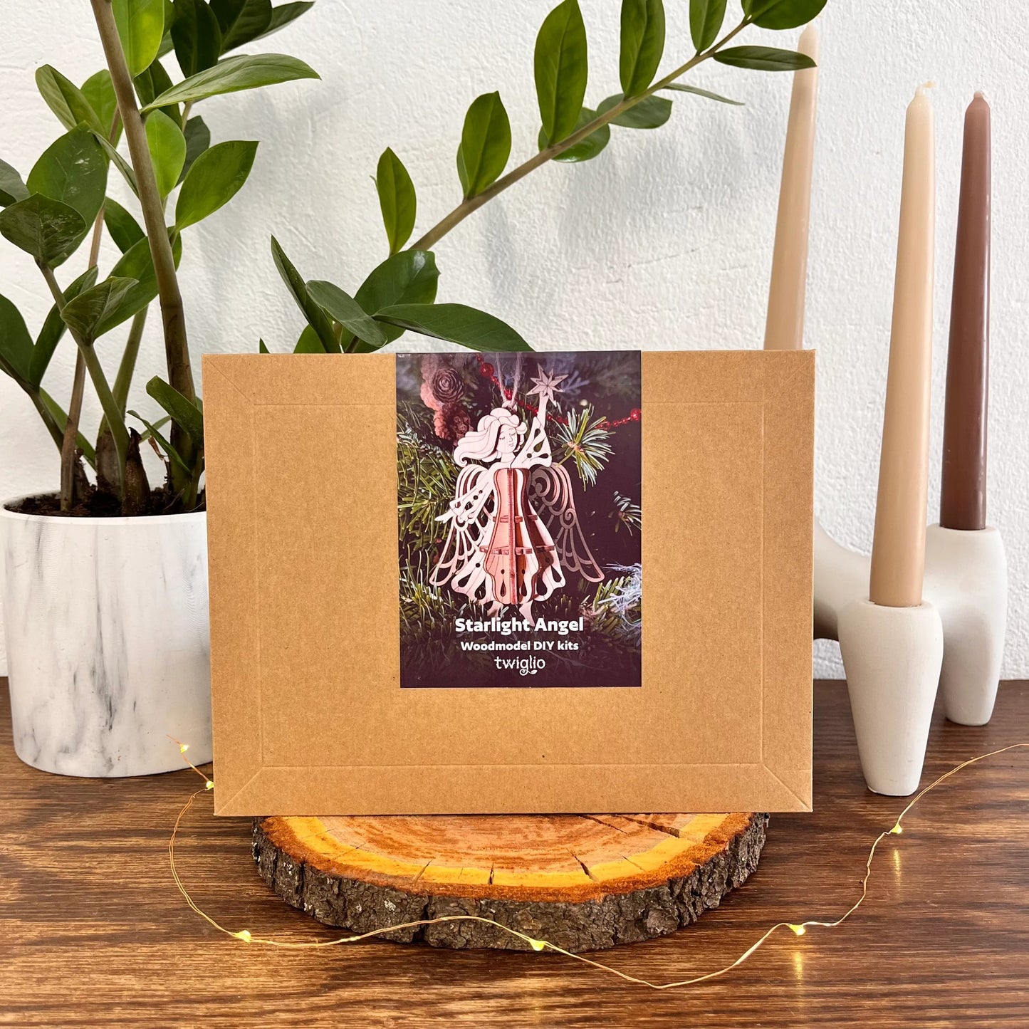 Kraft paper box with a decorative label on a wooden surface with plants and candles in the background