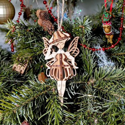 Wooden fairy ornament on a Christmas tree with red beads and pine cones.