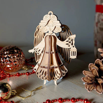 Wooden angel ornament with Christmas decorations on a wooden surface
