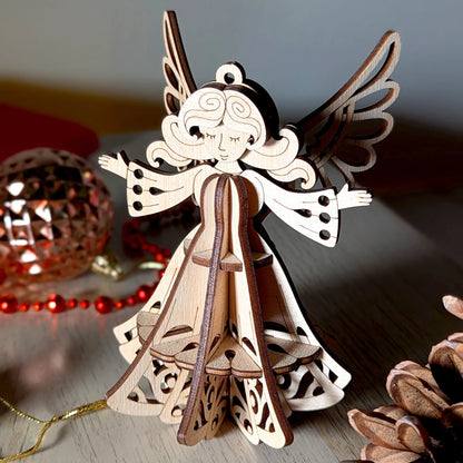 Wooden angel ornament on a reflective surface with blurred background