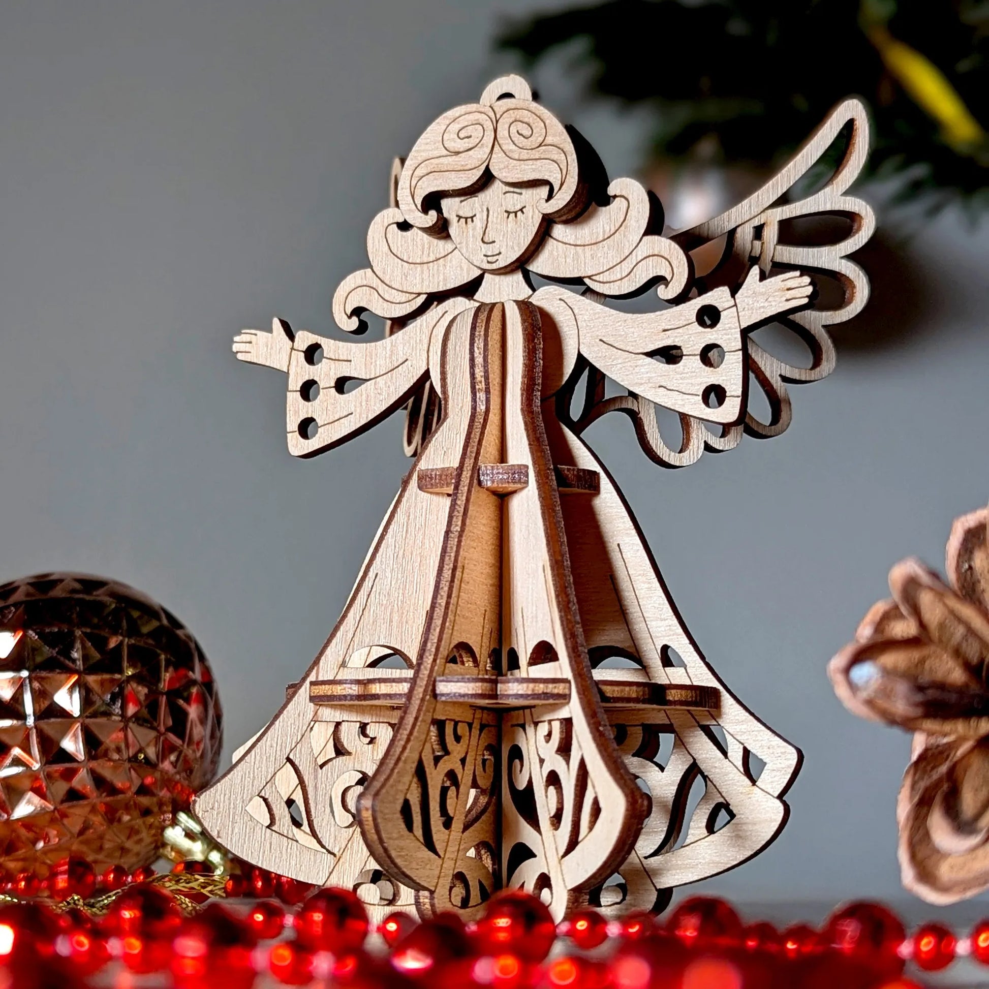 Wooden angel ornament with a lyre on a gray background