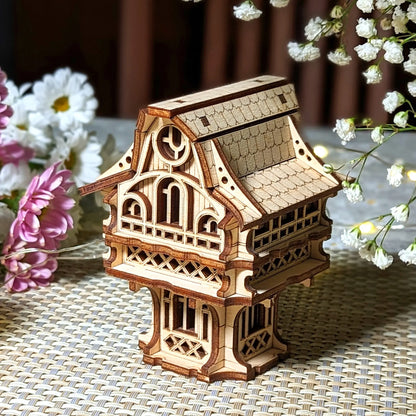 Wooden model of a decorative building with flowers in the background