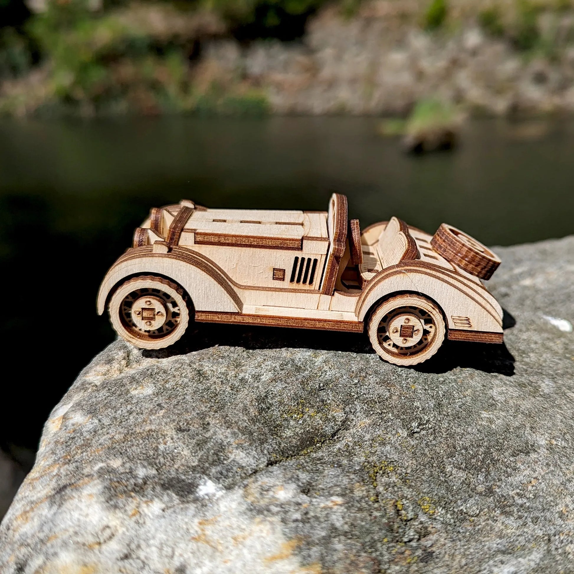 Handmade plywood convertible car model with antique-inspired styling and intricate laser-cut details.