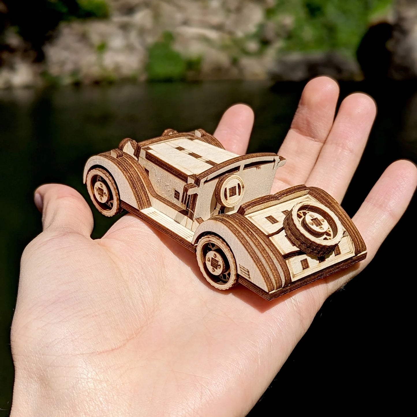 Retro open-top wooden car model crafted from layered plywood pieces, featuring classic fenders and detailed wheels.