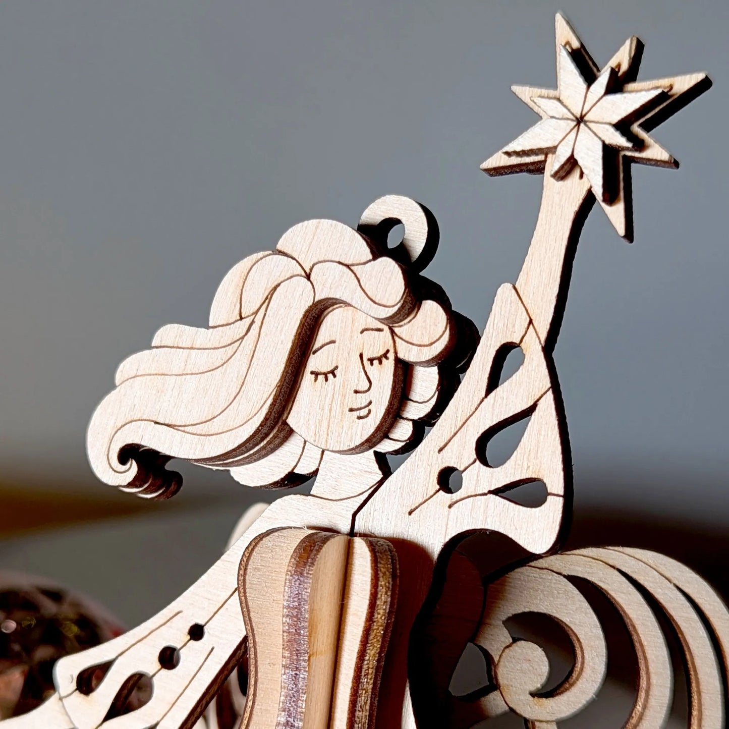 Wooden nativity scene figure with a star on a blurred background
