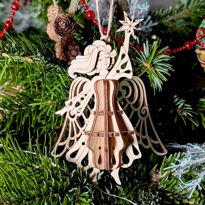 Wooden angel ornament on a Christmas tree with green branches and red decorations.