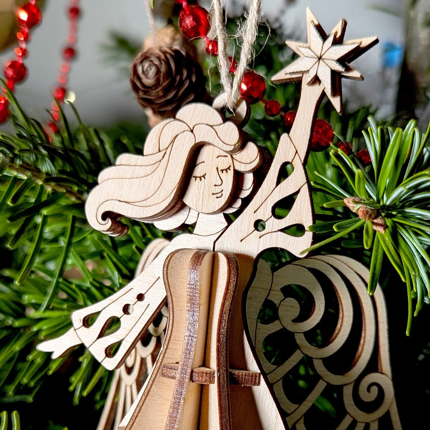 Wooden angel ornament with a star on a Christmas tree