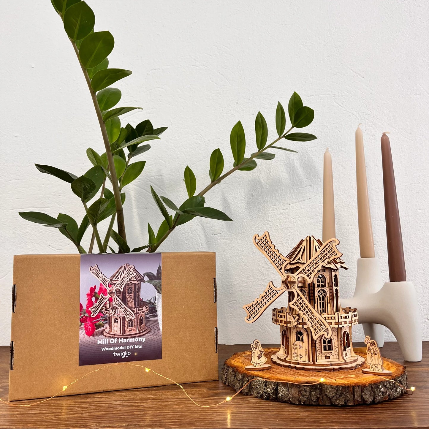 DIY kit packaging with mill on a wooden surface with plants and candles in the background.